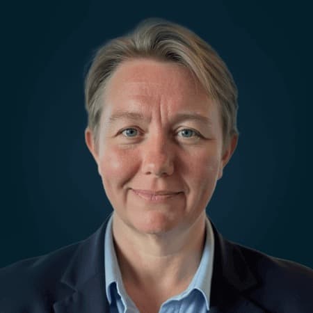 Portrait of ActivTrak CEO Heidi Farris against a dark blue background