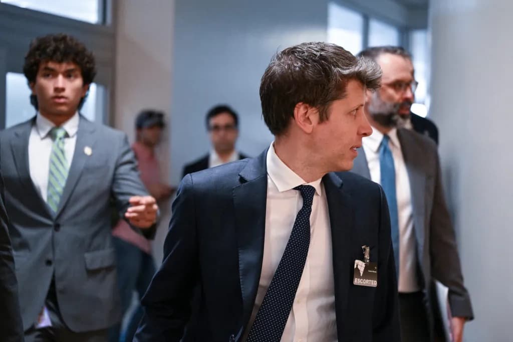A man wearing an escorted visitor badge walking through a hallway surrounded by other people