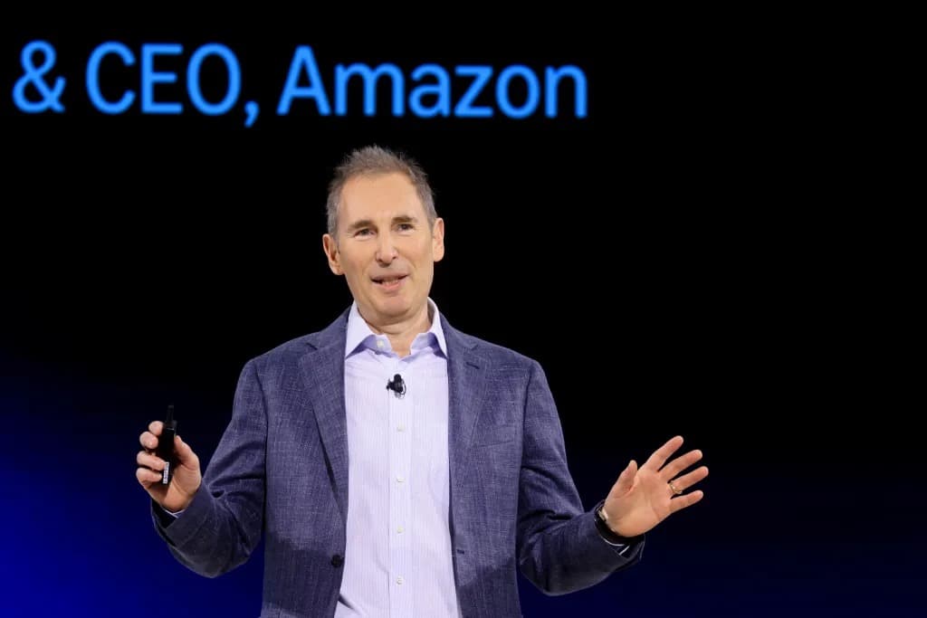 Amazon CEO Andy Jassy speaking on stage with a slide reading CEO, Amazon behind him