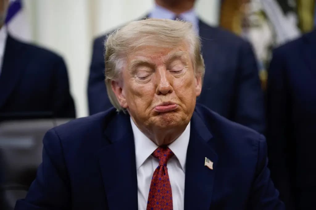 President Trump with his eyes closed, seated in the Oval Office surrounded by other officials