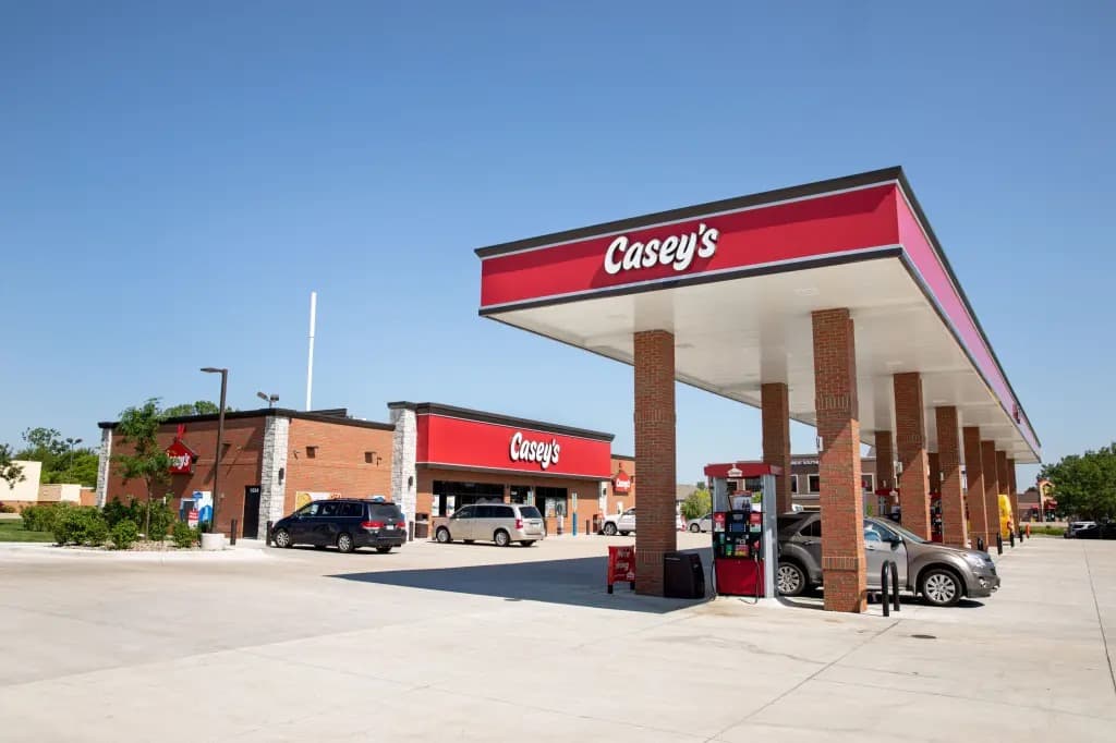 A Casey's gas station and convenience store with fuel pumps under a red canopy