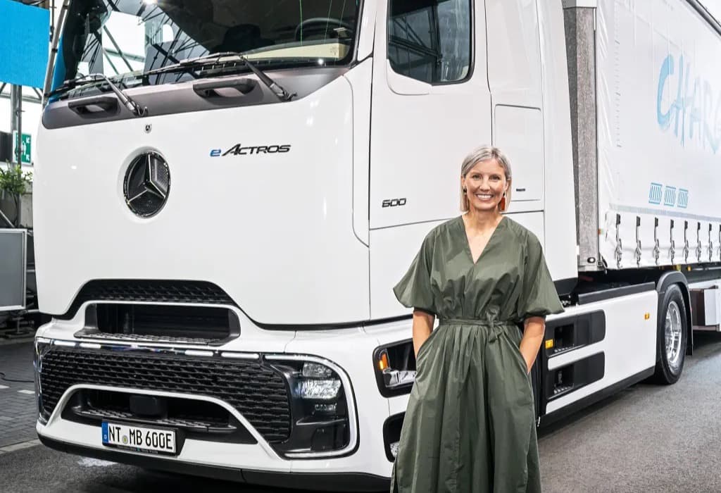 Daimler Truck CEO Karin Radstrom standing in front of a Mercedes-Benz eActros electric truck