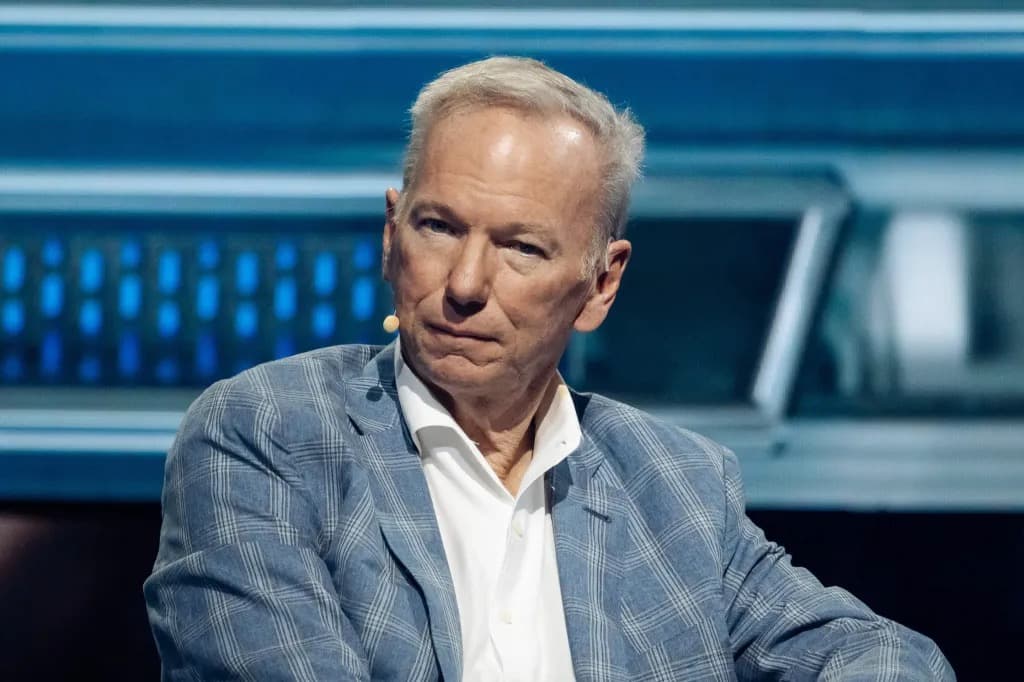Eric Schmidt seated on stage wearing a plaid blazer