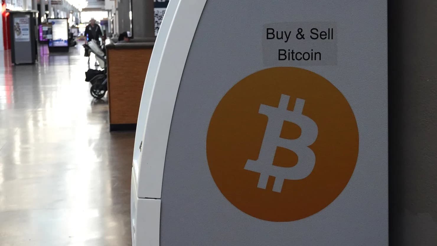 A Buy and Sell Bitcoin sign on a kiosk in a public terminal
