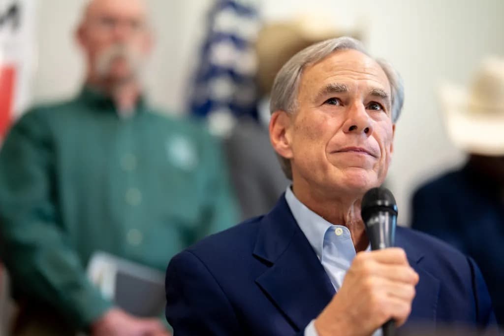 Texas Governor Greg Abbott speaking into a microphone at a podium