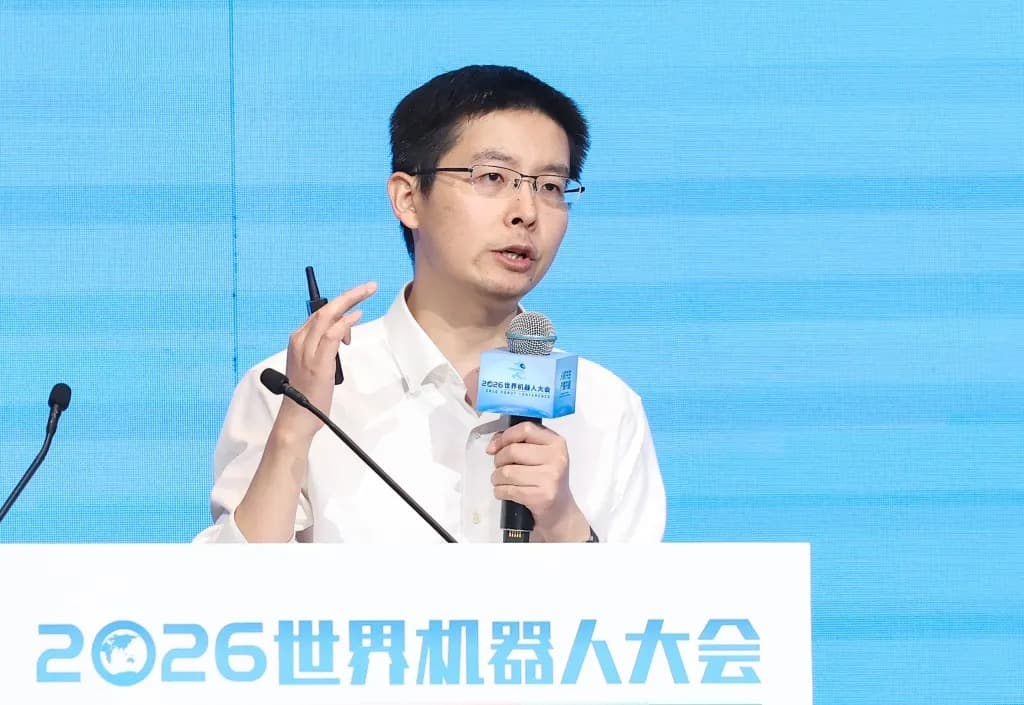Unitree CEO Wang Xingxing speaking at a podium at the 2026 World Robot Conference