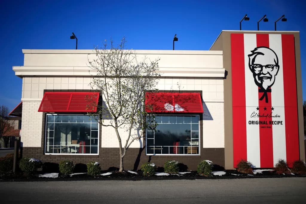 The exterior of a KFC restaurant with the Colonel Sanders logo displayed on the building